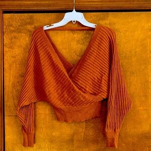Poof Apparel cross over sweater. Orange size small.